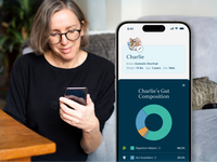 A woman watching the petivity app displaying her pet's gut composition health information.