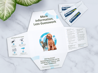 Packaging for a pet at-home oral health test showing instructions and information with images of a dog and cat on a white marble surface