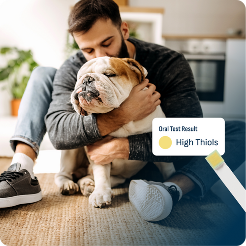 Man hugging a bulldog Dog, next to an oral test result graphic showing high thiols